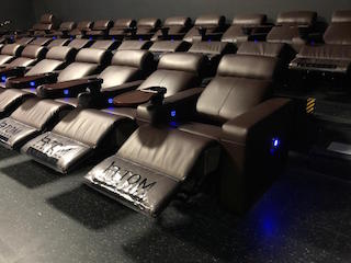 Apple Cinemas in Simsbury, Connecticut has installed nearly seven hundred Atom Seating Neon Recliners with swivel tables in eight auditoriums.