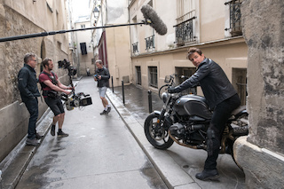 Left to right: director Christopher McQuarrie, B camera/Steadicam operator Marcus Pohlus and Tom Cruise on the set of Mission Impossible – Fallout, from Paramount Pictures and Skydance. The Lectrosonics SMV transmitter is located next to the wind-protected shotgun microphone.
