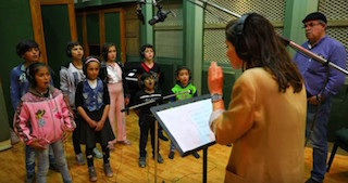 Music director Esmeralda Conde Ruiz rehearses with a choir of ten Syrian Children.