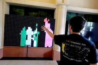 A USC students enjoys the Christie Microtiles display