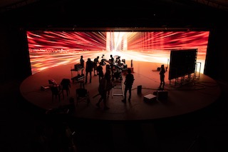 The setup comprised an LED wall with a stage radius of 16 meters, made up from Unilumin Upad III LED panels supplied by MGX Studio’s LED distributor, Ledeca, driven by three Tessera SX40 4K LED processors and five Tessera XD data distribution units. The project used the concept of hybrid technology, utilizing both Unreal Engine and video mapping techniques in real time. The entire system was powered by the disguise Extended Reality workflow.
